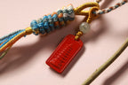 Colorful Woven Tassel Charm with Red Tag — product image 2