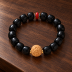 Blackwood beaded bracelet with carved wood charm - editorial view