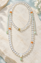 Clear crystal beaded necklace with jade pendant - complete flat lay
