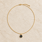 Quiet minimal pendant necklace on stone display