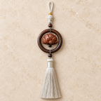 Warm Path lotus car charm on stone display